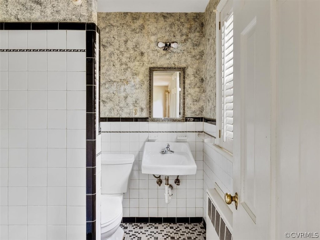 208 Ross Road Henrico, VA 23229 - Photo 23 of 31 a bathroom with a sink a mirror and a shower