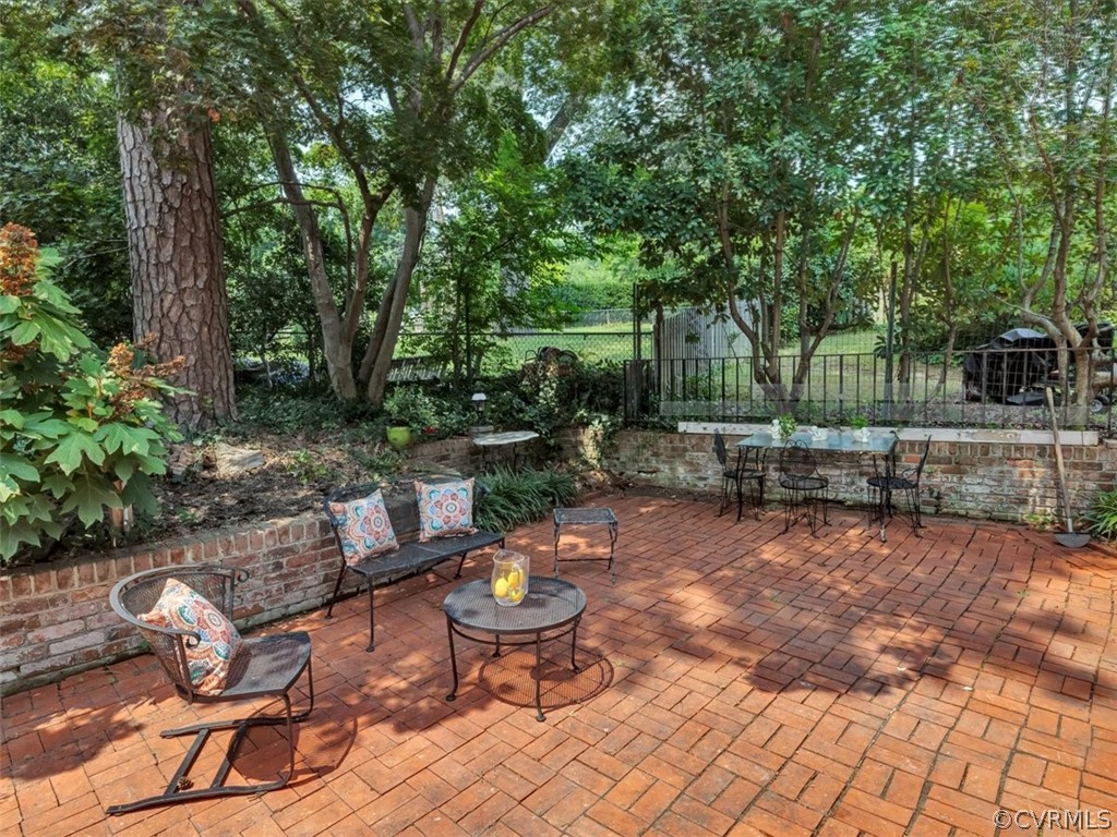 208 Ross Road Henrico, VA 23229 - Photo 29 of 31 a view of a backyard with table and chairs under an umbrella