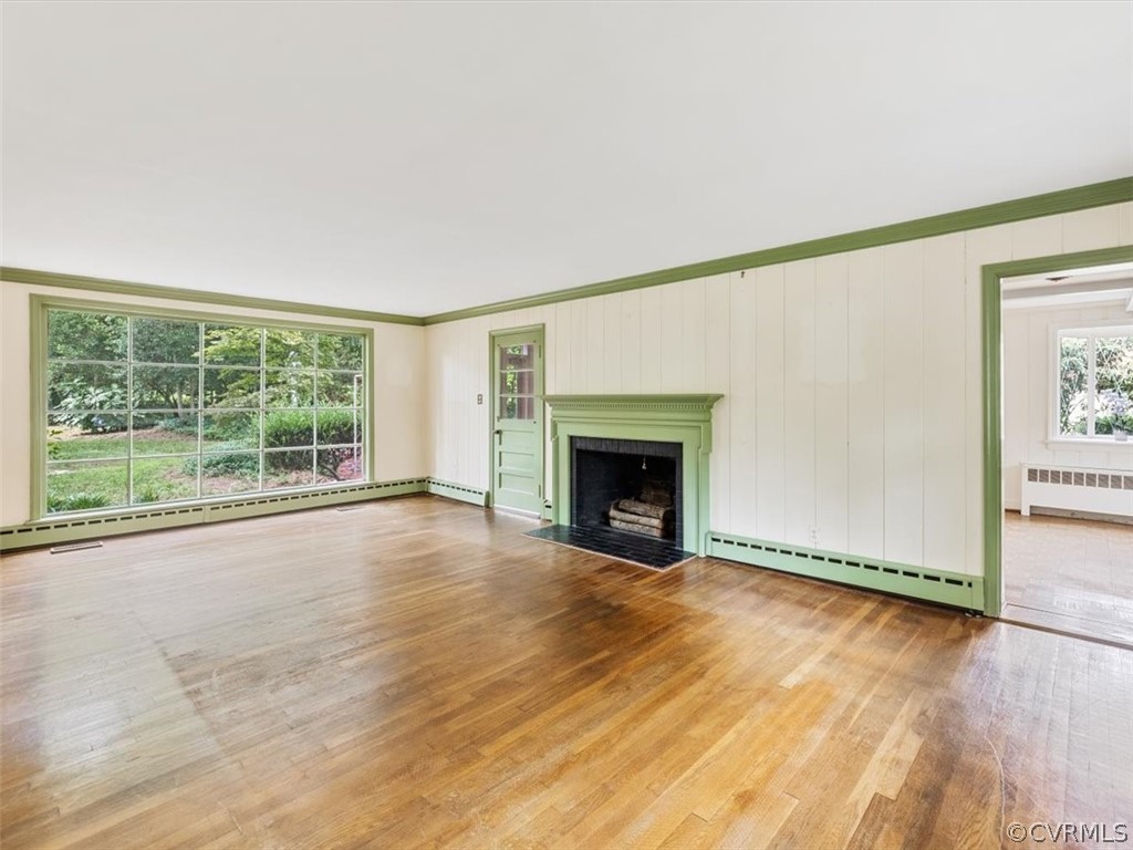 208 Ross Road Henrico, VA 23229 - Photo 7 of 31 a view of an empty room with wooden floor and a window