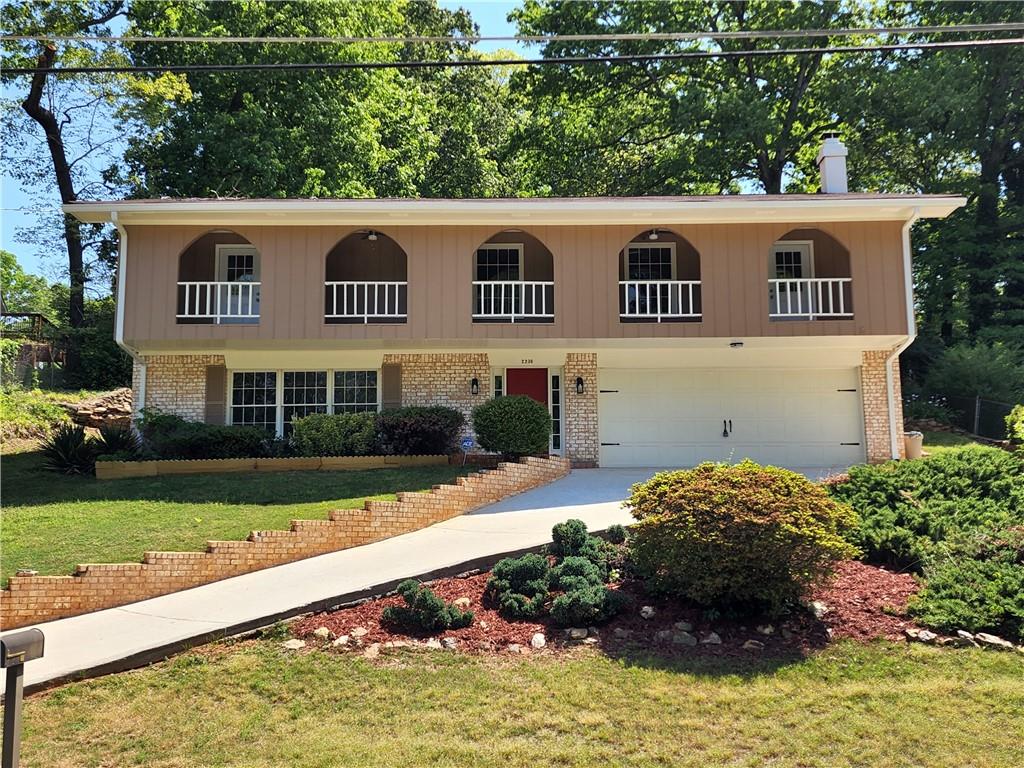 a view of an house with backyard space and balcony