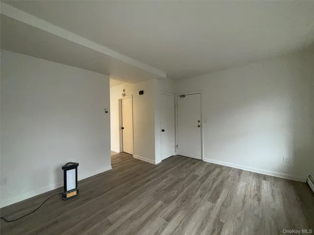 a view of an empty room and wooden floor