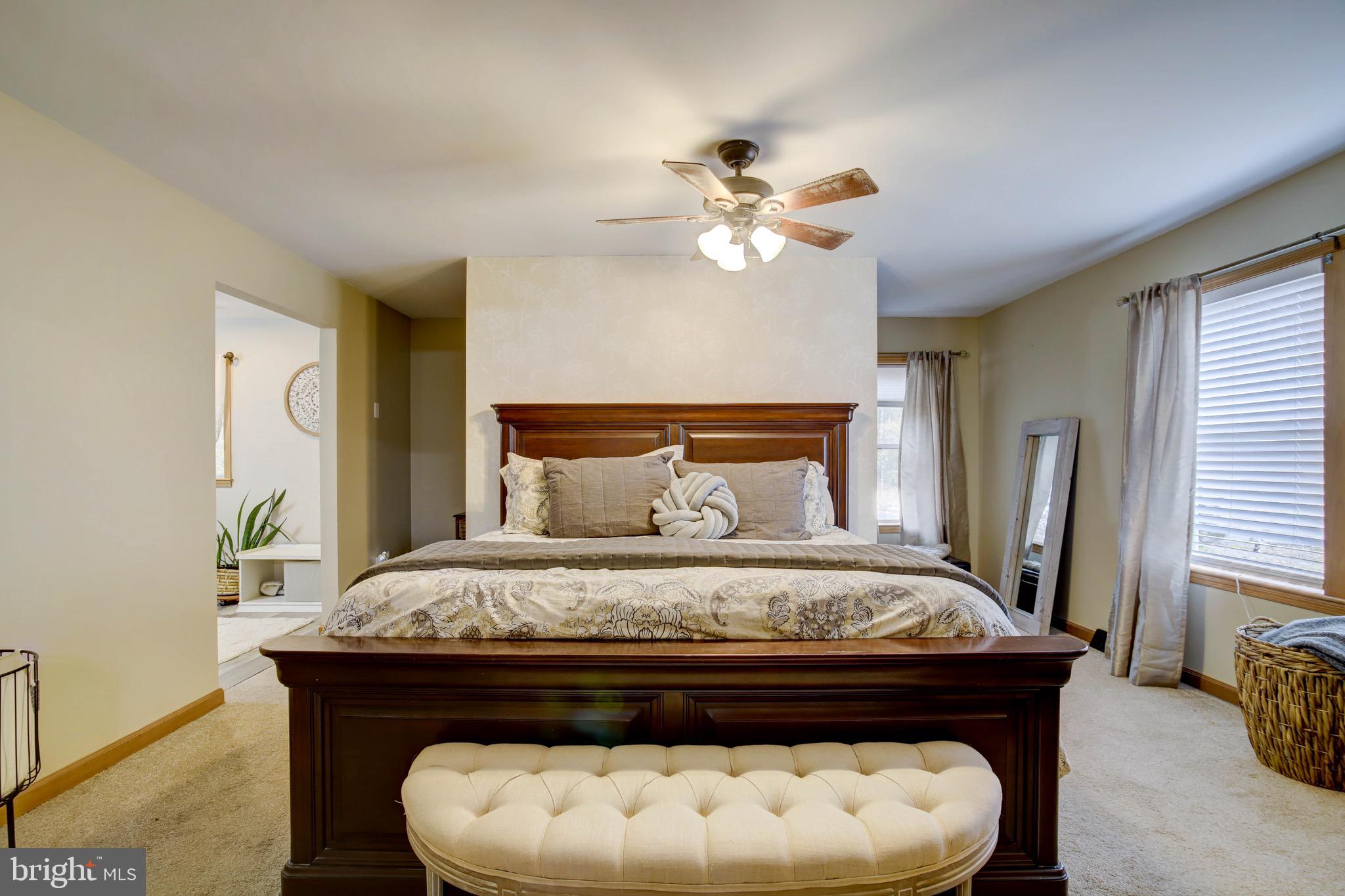 5520 Indiantown Road Rhodesdale, MD 21659 - Photo 29 of 51 a bed sitting in a bedroom next to a window with a chandelier