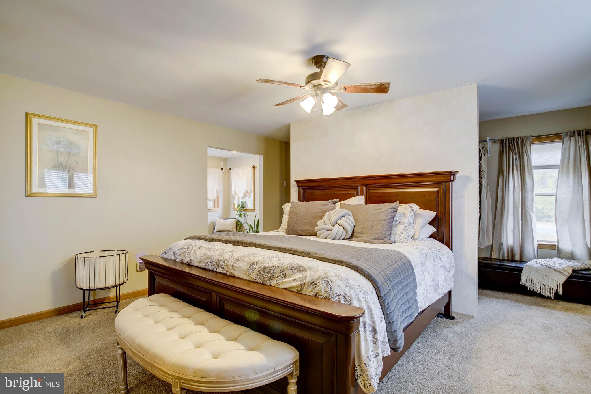 5520 Indiantown Road Rhodesdale, MD 21659 - Photo 32 of 51 a bedroom with a bed and a chandelier