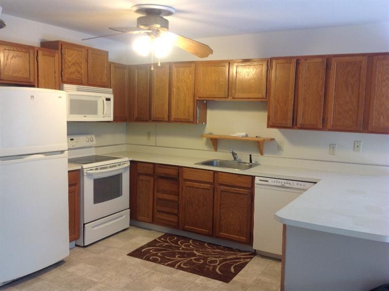 11 Round House Road, Unit 11 Bourne, MA 02532 - Photo 4 of 23 a kitchen with stainless steel appliances granite countertop a sink a stove a refrigerator and cabinets