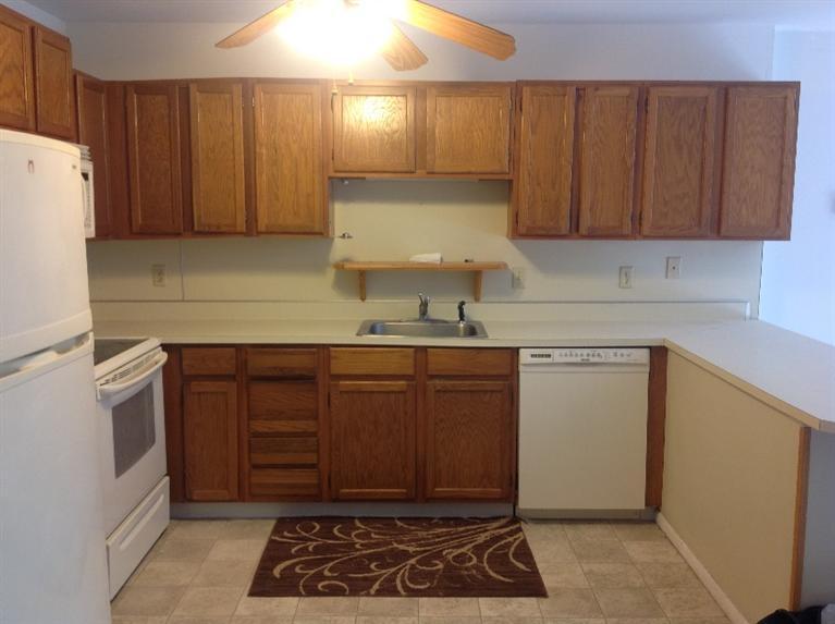 11 Round House Road, Unit 11 Bourne, MA 02532 - Photo 5 of 23 a kitchen with a sink cabinets and a refrigerator