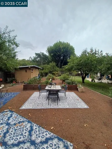 a view of a backyard with sitting area