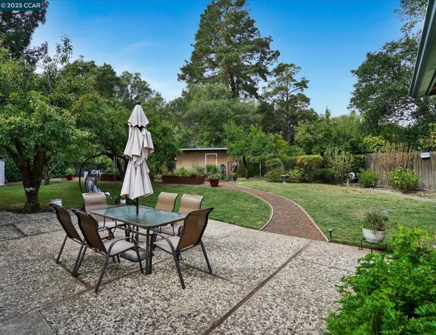 a view of a yard with furniture and a garden