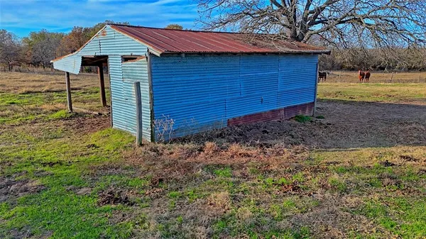 a house is sitting in middle of the garden