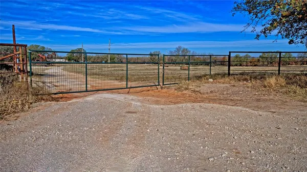 a view of a tennis court with wooden fence