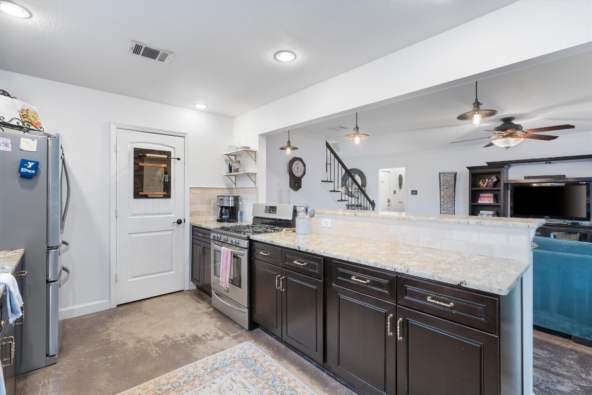 1808 Chincoteague Way Round Rock, TX 78681 - Photo 13 of 40 a kitchen with stainless steel appliances granite countertop a sink and stove