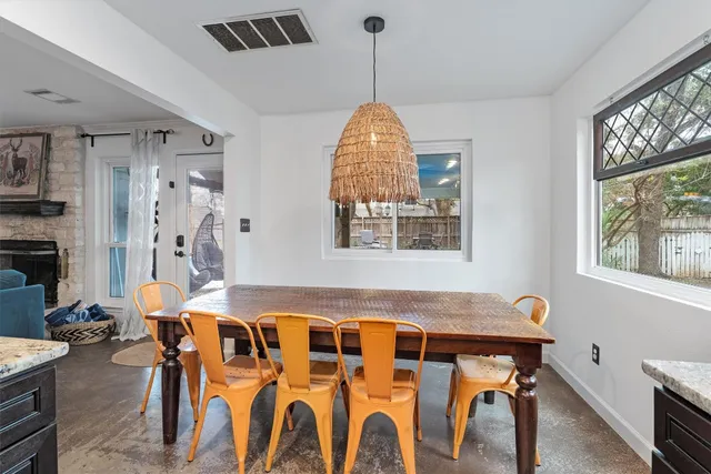 a view of a dining room with furniture and window