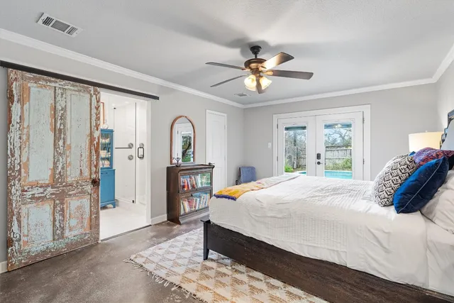 a bedroom with a bed and wooden floor