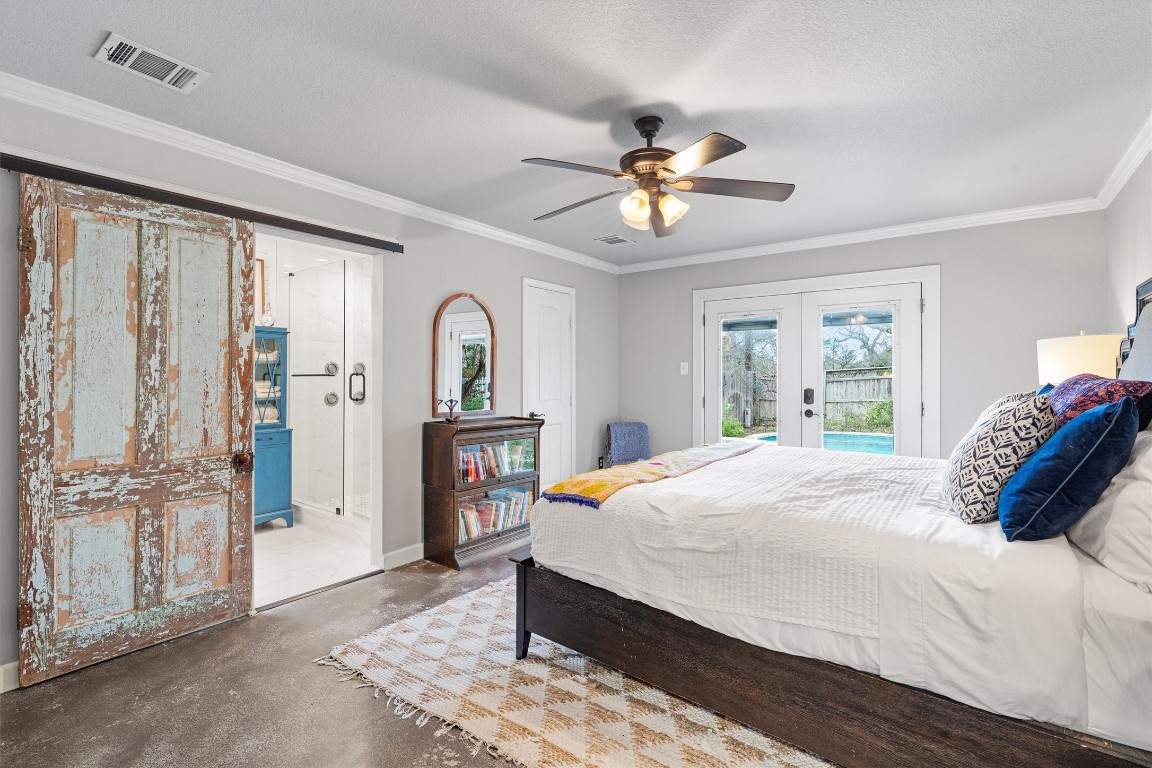1808 Chincoteague Way Round Rock, TX 78681 - Photo 16 of 40 a bedroom with a large bed and a chandelier