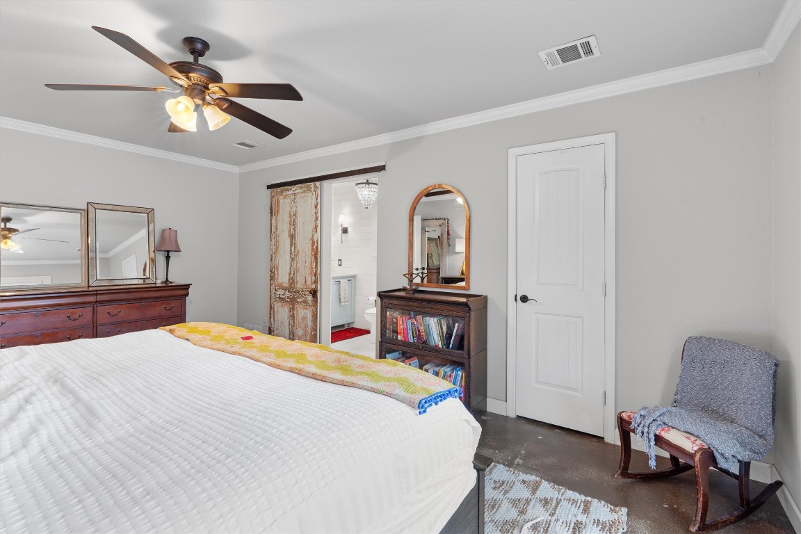 1808 Chincoteague Way Round Rock, TX 78681 - Photo 18 of 40 a bedroom with a bed and a chandelier