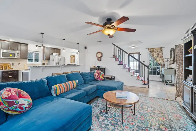 a living room with furniture and a chandelier