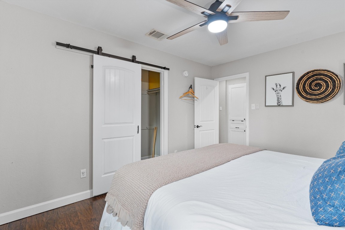 1808 Chincoteague Way Round Rock, TX 78681 - Photo 27 of 40 a bedroom with a bed and a chandelier