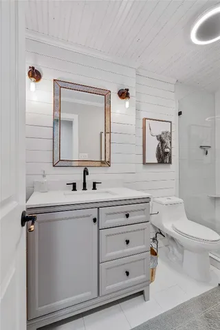 a bathroom with a toilet and a shower