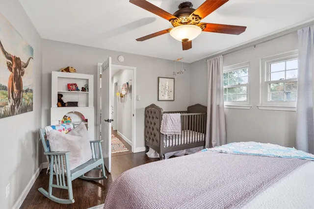 a living room filled with furniture and a floor to ceiling window