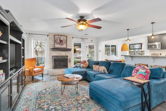 a living room with furniture a flat screen tv and a fireplace