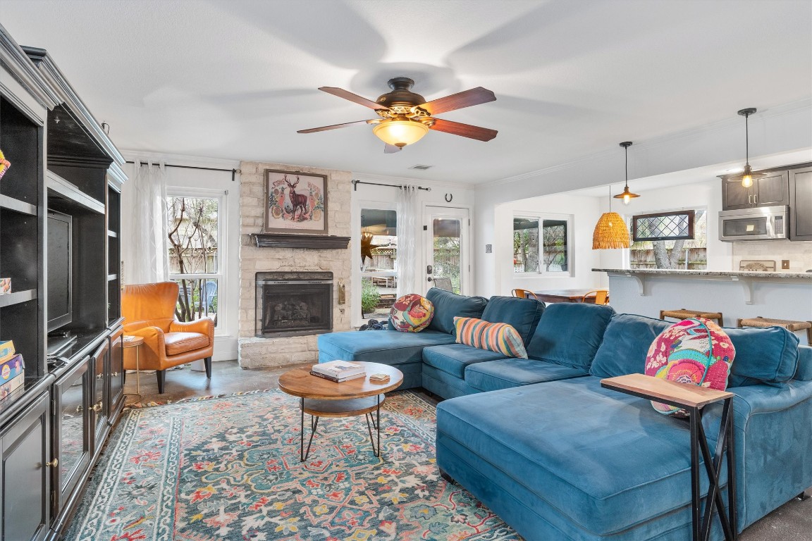 1808 Chincoteague Way Round Rock, TX 78681 - Photo 7 of 40 a living room with furniture a flat screen tv and a fireplace