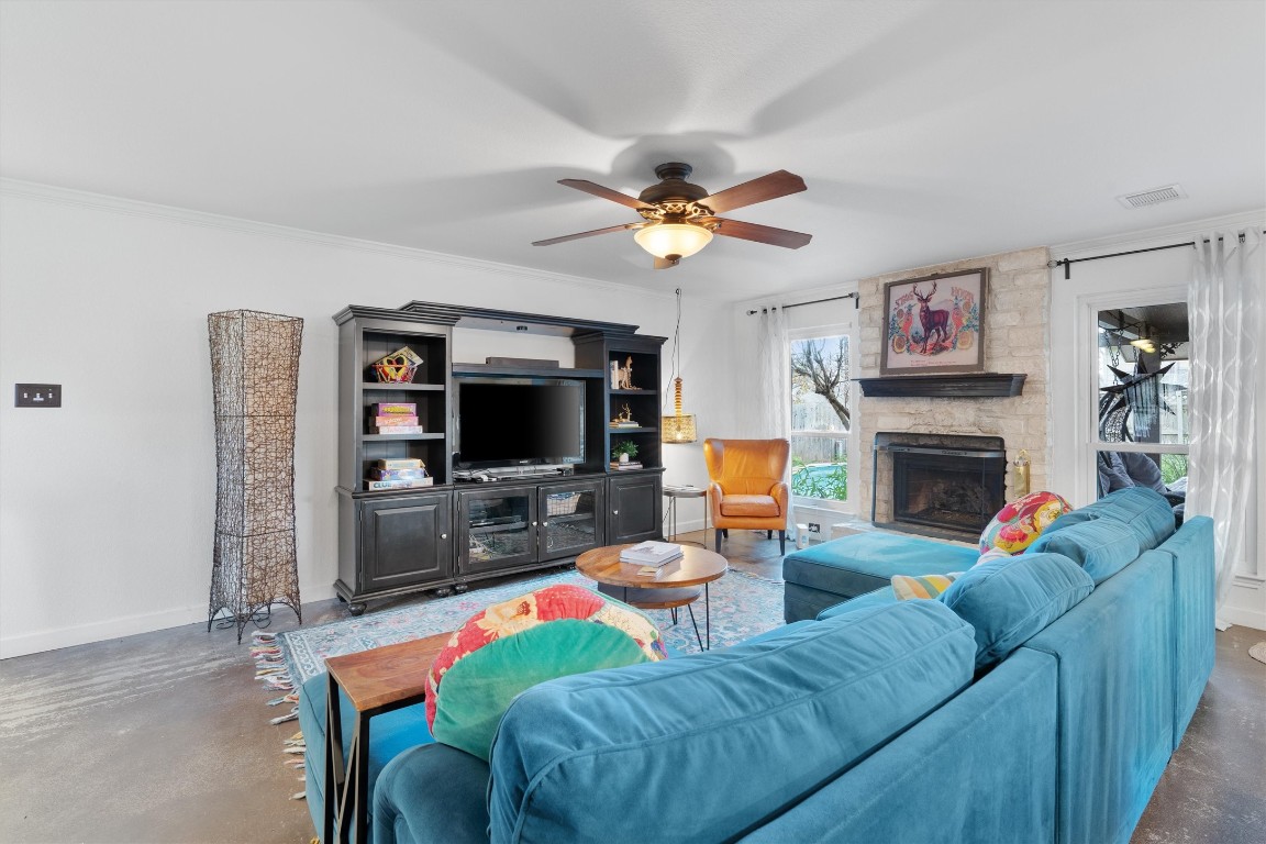 1808 Chincoteague Way Round Rock, TX 78681 - Photo 8 of 40 a living room with furniture a flat screen tv and a fireplace