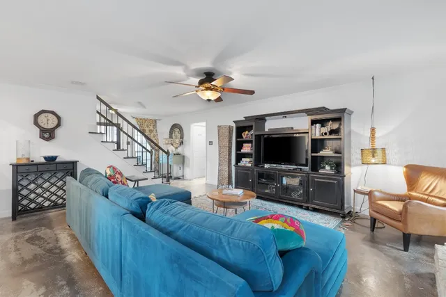 a large kitchen with cabinets chairs and stainless steel appliances