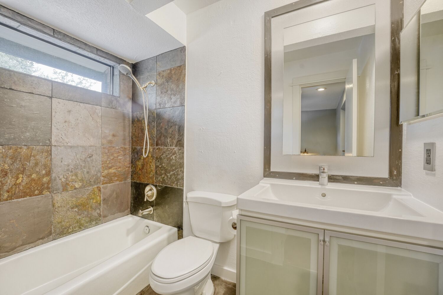 8200 Neely Drive, Unit 214 Austin, TX 78759 - Photo 13 of 19 a bathroom with a sink a toilet and shower