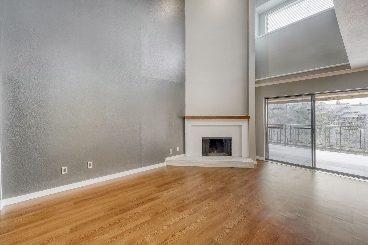 8200 Neely Drive, Unit 214 Austin, TX 78759 - Photo 3 of 19 a view of empty room with wooden floor and fireplace