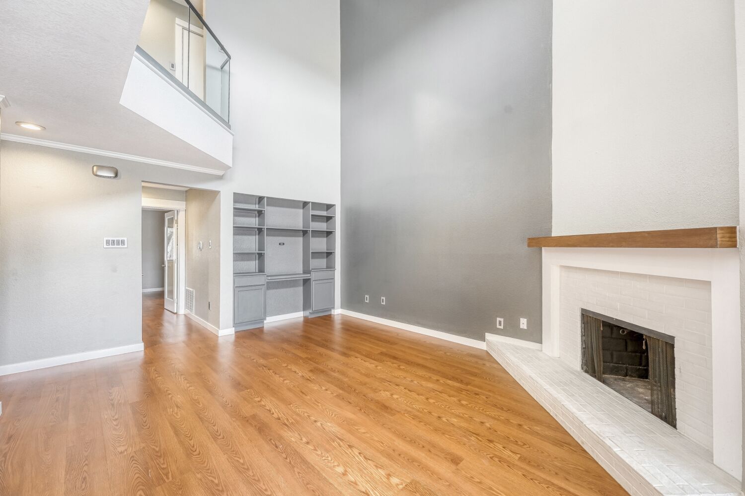 8200 Neely Drive, Unit 214 Austin, TX 78759 - Photo 4 of 19 a view of an empty room with wooden floor and a fireplace