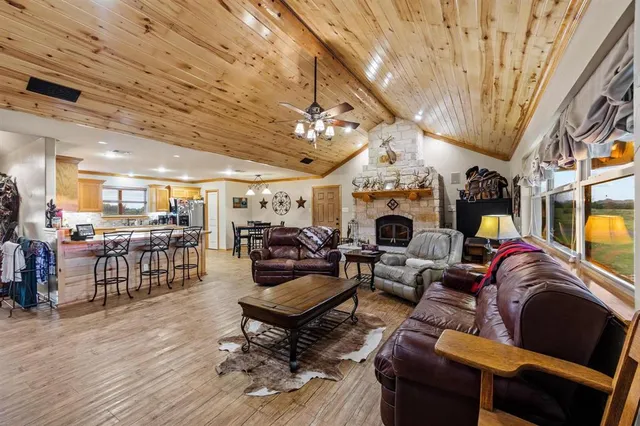 a living room with furniture a fireplace and a chandelier