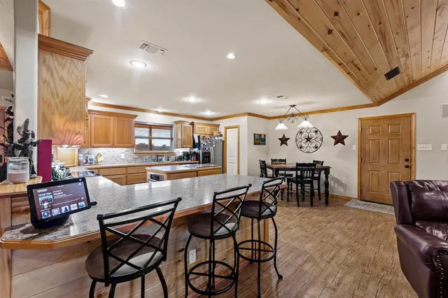 a dining room with furniture and a kitchen view