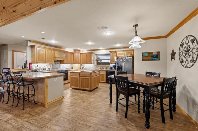 a kitchen with a table chairs and a refrigerator