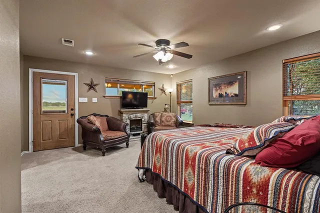 a bedroom with a bed a couch and a chandelier