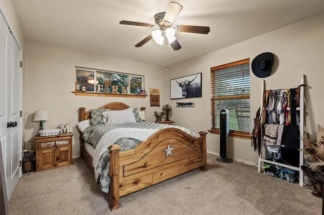 a bedroom with bed and a chandelier