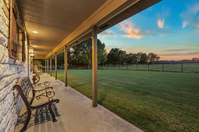 a view of a chair and tables in the patio
