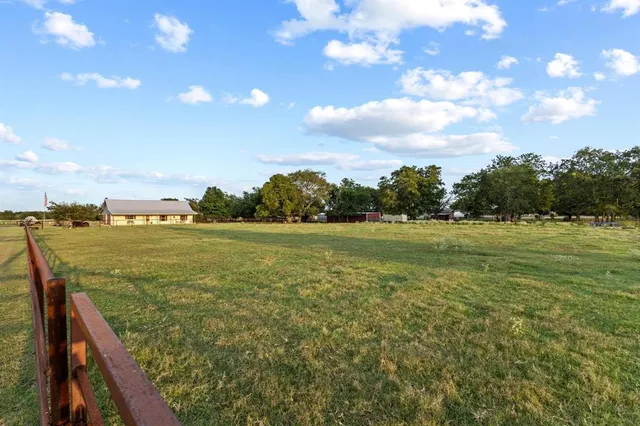 a view of a field with an ocean