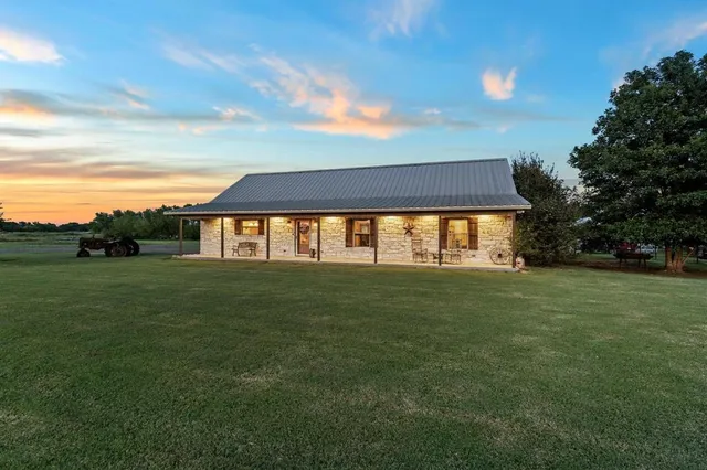 a front view of house with outdoor space and trees
