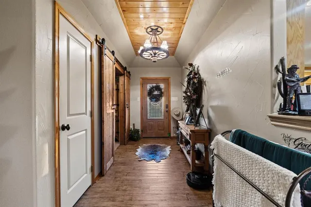 a view of a hallway with couch and wooden floor