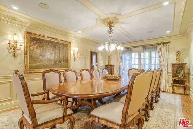 a dining room with furniture a chandelier and wooden floor