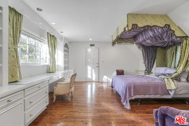 a bedroom with furniture and a chandelier