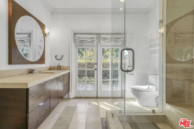 a bathroom with a toilet sink and mirror