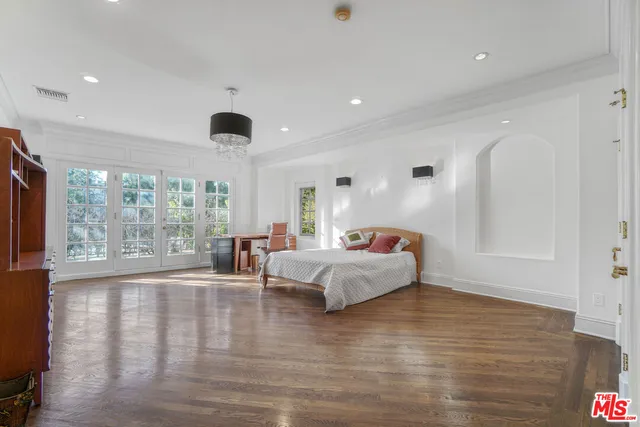 a living room with furniture and large windows