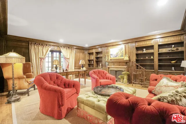 a living room with furniture a lamp and a large window