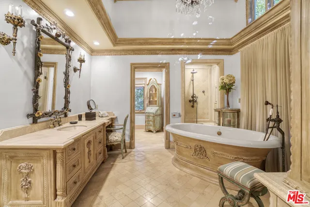 a spacious bathroom with a double vanity sink a mirror and a bathtub