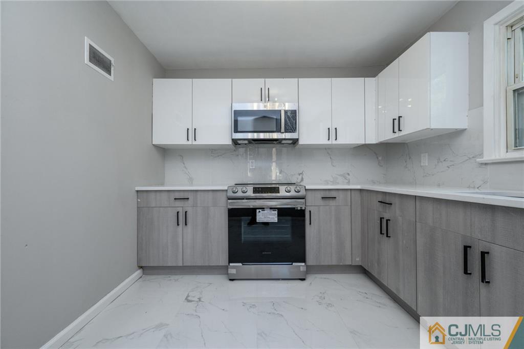 628 Concord Circle Ewing, NJ 08618 - Photo 20 of 48 a kitchen with granite countertop white cabinets and stainless steel appliances