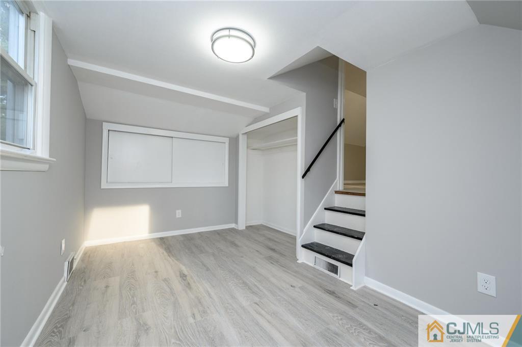 628 Concord Circle Ewing, NJ 08618 - Photo 37 of 48 a view of empty room with stairs and wooden floor