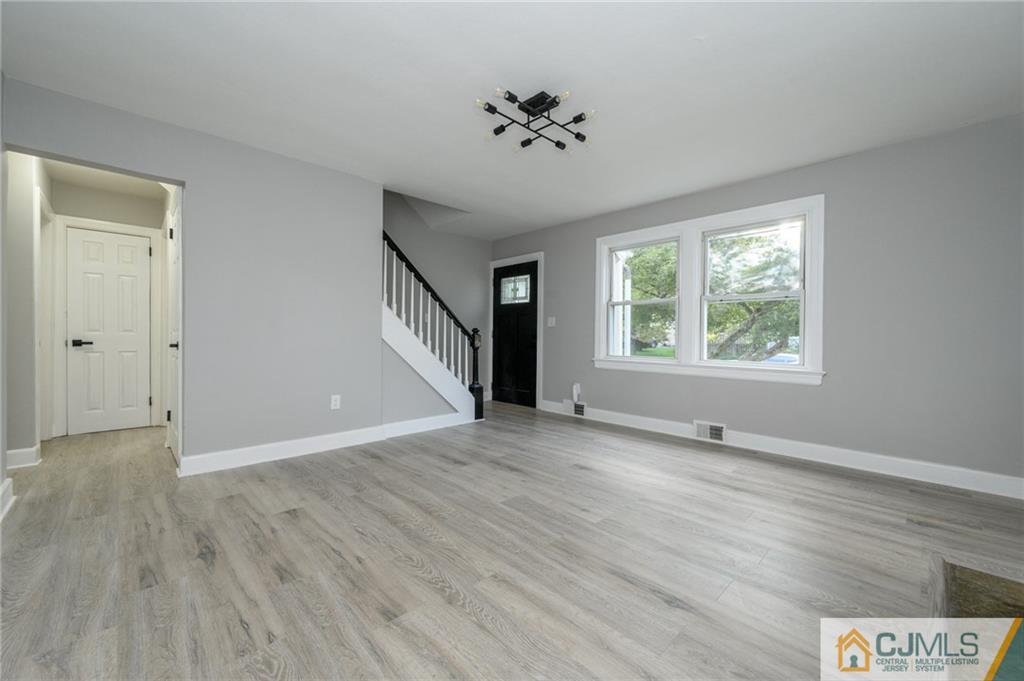 628 Concord Circle Ewing, NJ 08618 - Photo 6 of 48 an empty room with wooden floor cabinet and windows