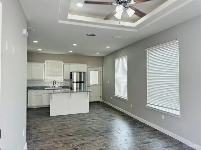 a kitchen with stainless steel appliances granite countertop a stove and cabinets