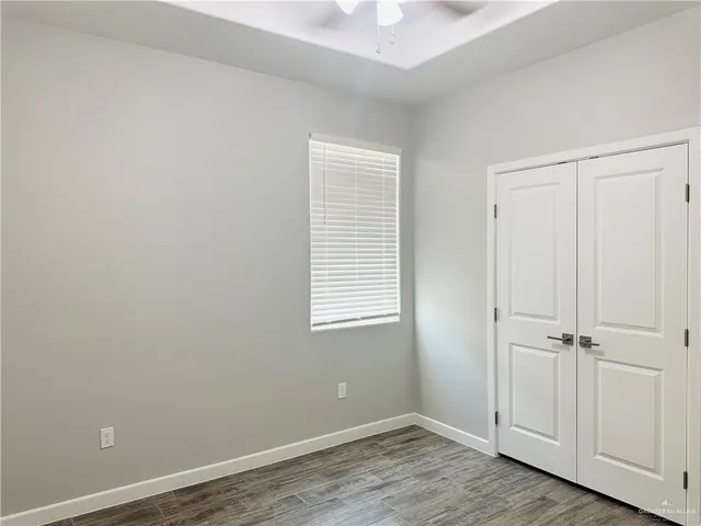 an empty room with wooden floor