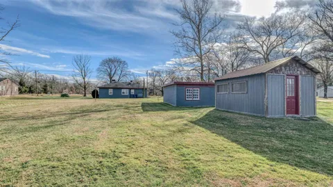 a large house with a big yard and large trees